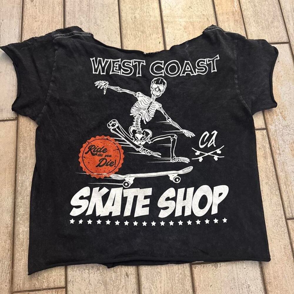 Black cropped tee with white skeleton skateboarding graphic